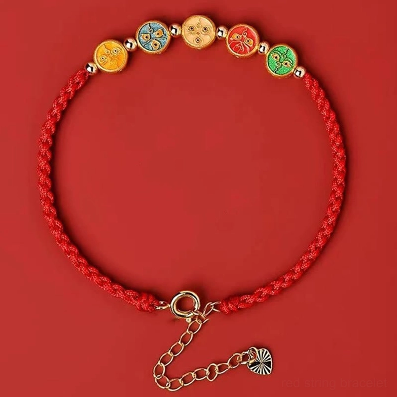 full enamel five god of wealth red string bracelet flat lay on solid red background