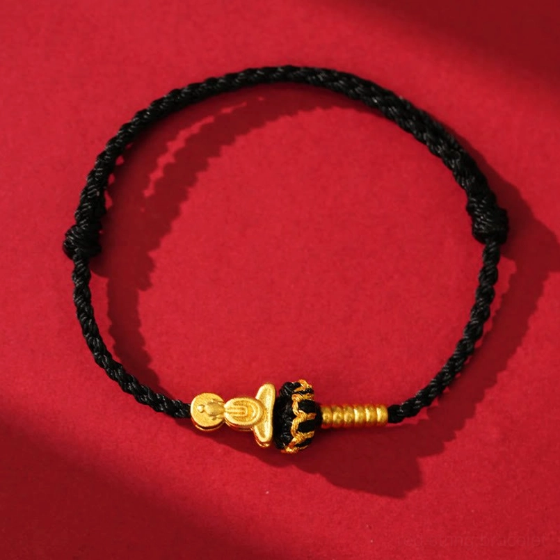 Black string Formless Buddha protection bracelet with gold charm overhead flat lay