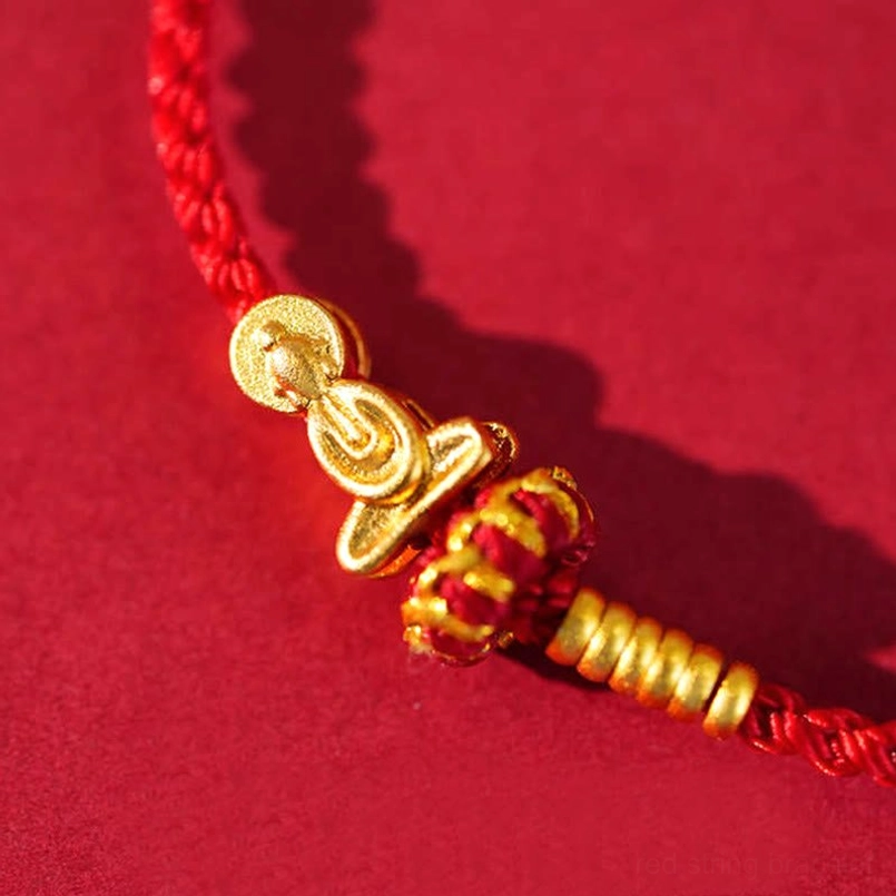 Extreme close-up showing Formless Buddha charm and red enamel decorated gold ornament
