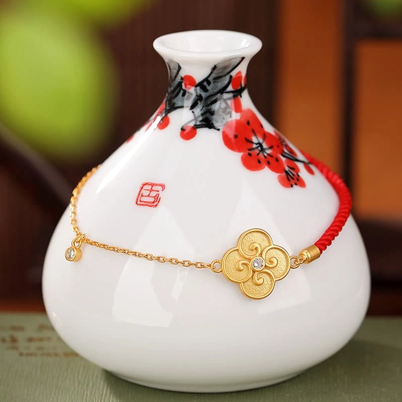 Sterling silver gold-plated four-leaf clover charm bracelet close-up front view