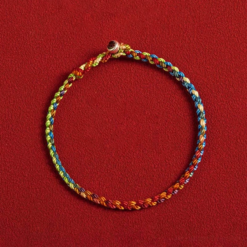 Red string bracelet with 925 sterling silver metal round clasp detailed overhead view