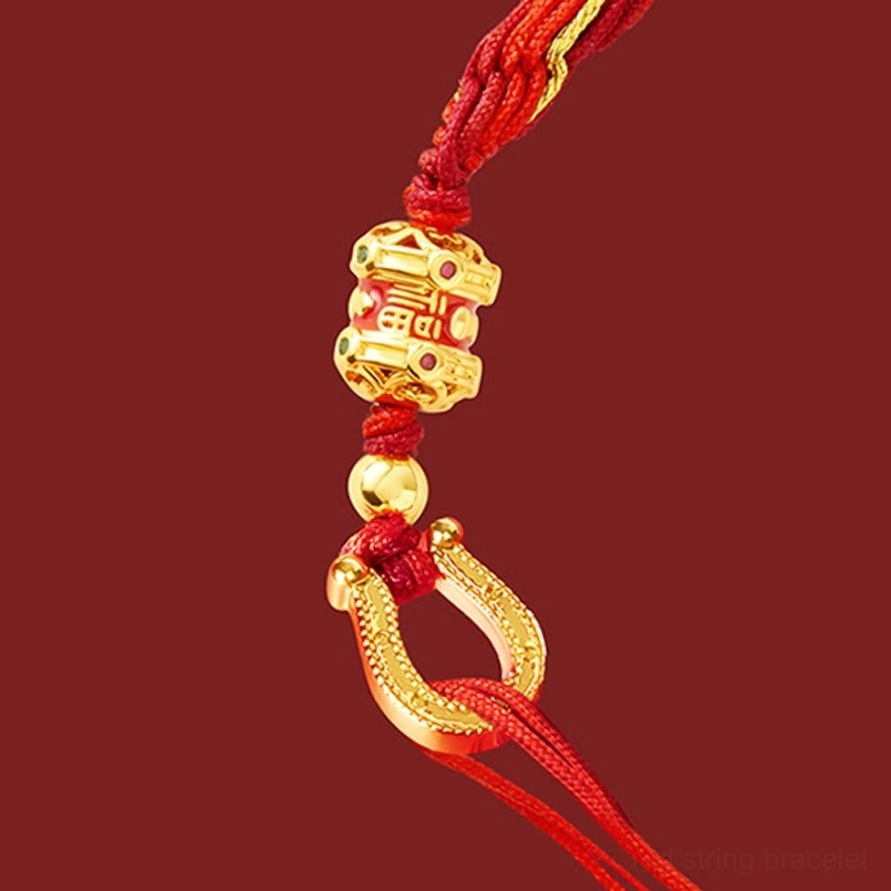 Macro close-up of Year of the Horse bracelet components showing engraved gold Fu beads, woven red cord, and gold clasp