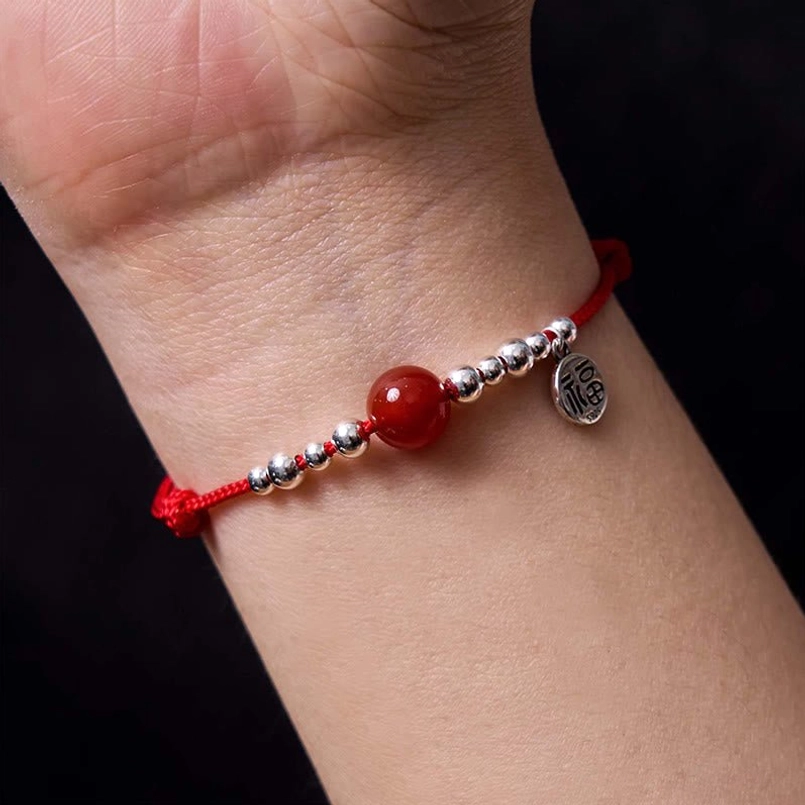 Red agate fortune bracelet worn on wrist showing comfortable fit and silver details