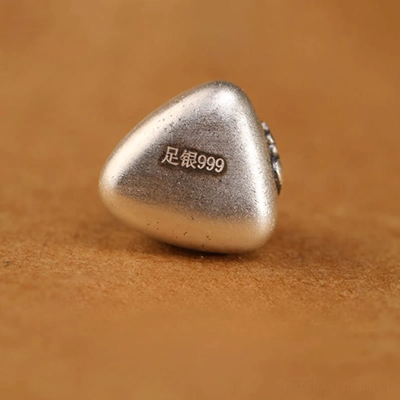 Fu character engraved on 999 sterling silver zongzi pendant close up