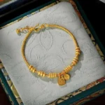 24K gold plated Fu character blessing bracelet with dual pendants in embroidered jewelry gift box