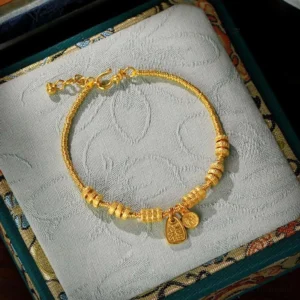 24K gold plated Fu character blessing bracelet with dual pendants in embroidered jewelry gift box