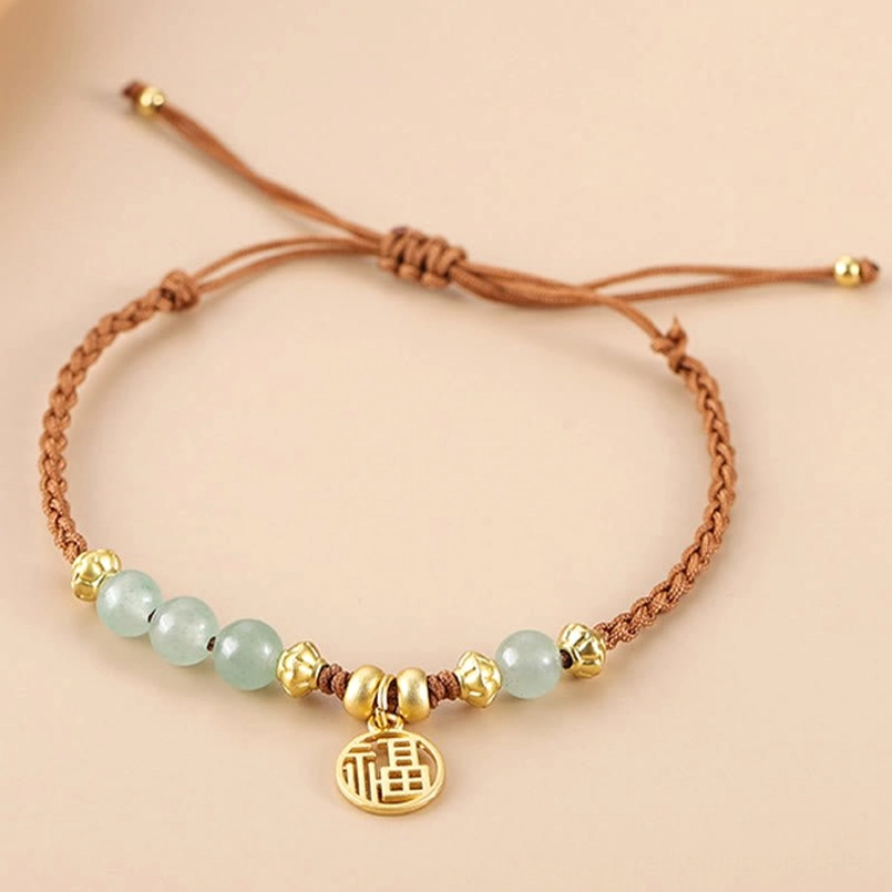 Fu charm jade bead red string bracelet front view on plain background