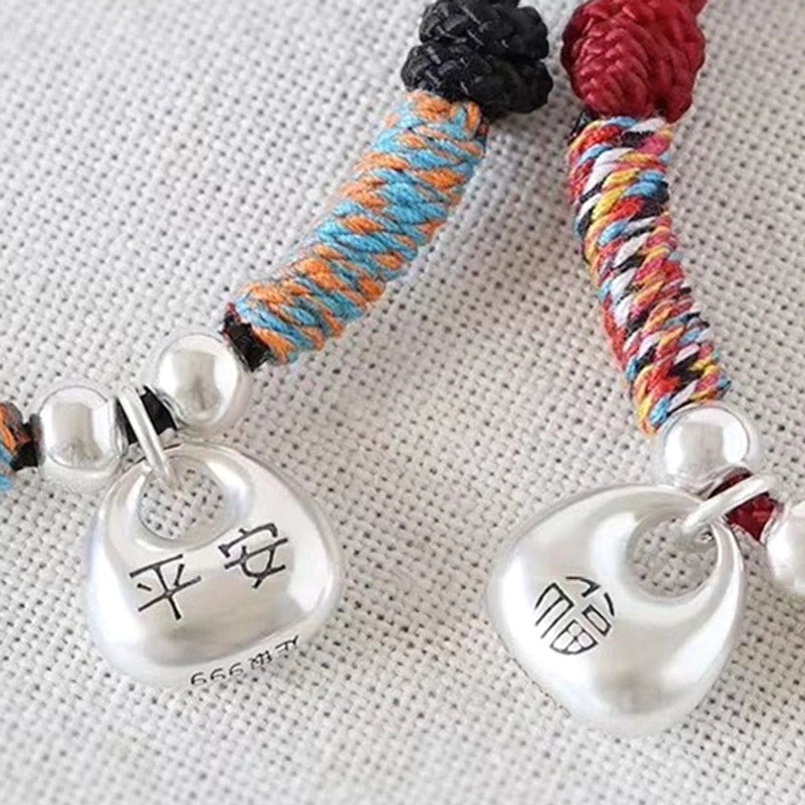 Red string Fu bracelet placed on gift box as thoughtful good luck present