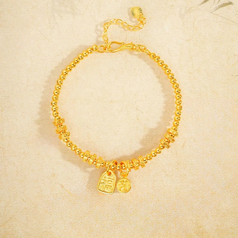 Gold plated Fu character bracelet with dual pendants and intricately carved twisted chain design