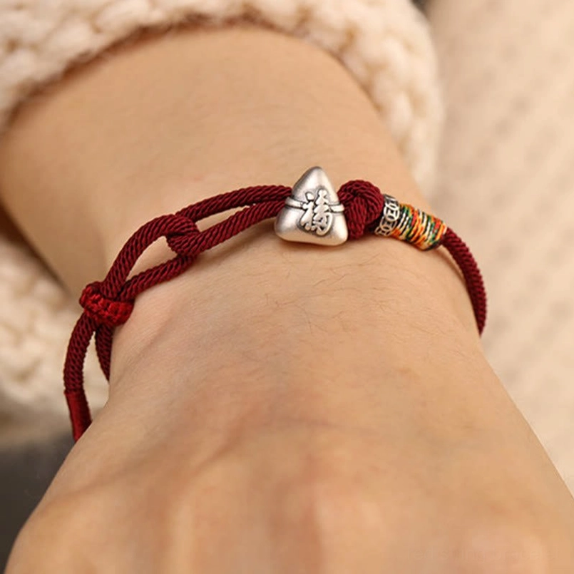 Dark red fu zongzi luck bracelet wearing effect on wrist side view