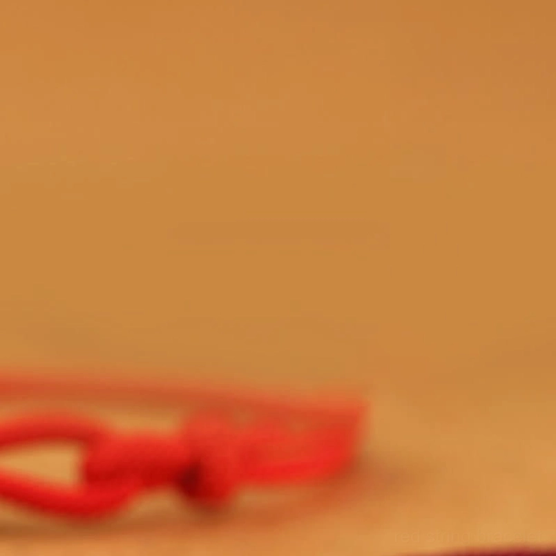Fu zongzi protection bracelet placed on brown desktop background