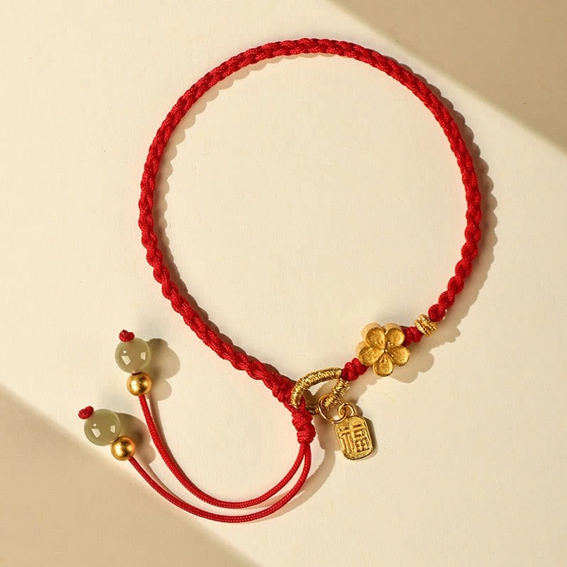 Full display of Hetian jade Fu charm red string bracelet on light background