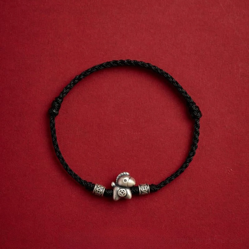 Full view of black zodiac horse sterling silver red string bracelet