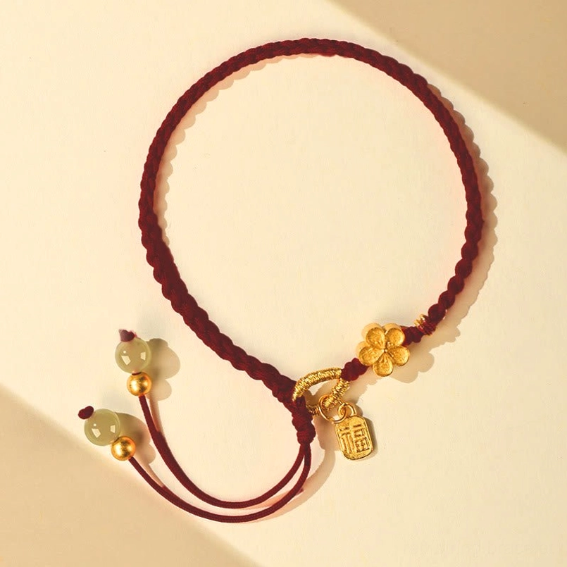 Full display of dark red Hetian jade red string bracelet on light background