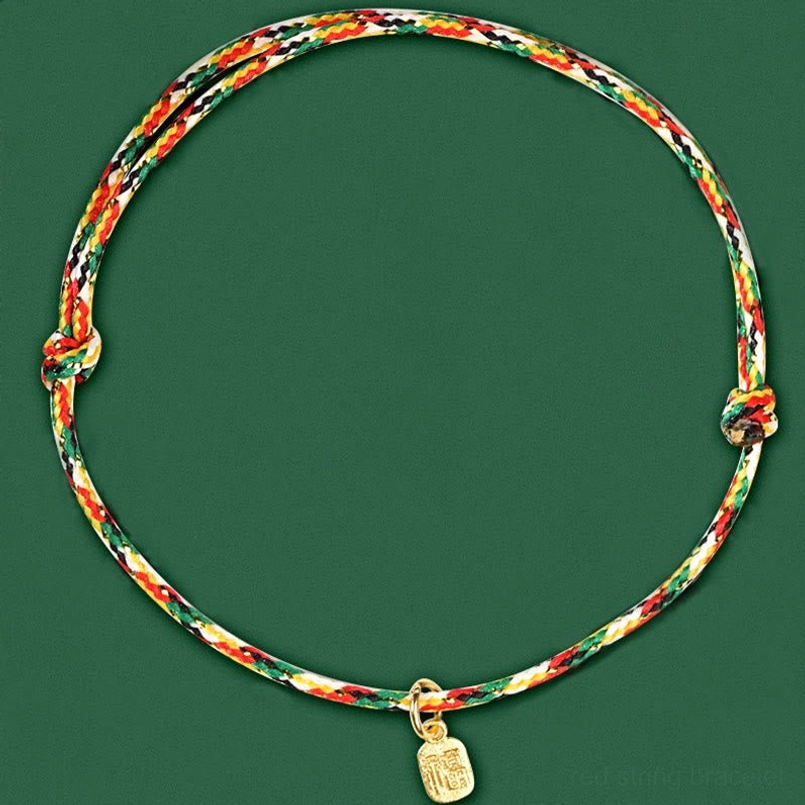 Full view of multicolor twisted lucky bracelet with decorative knots on dark green background