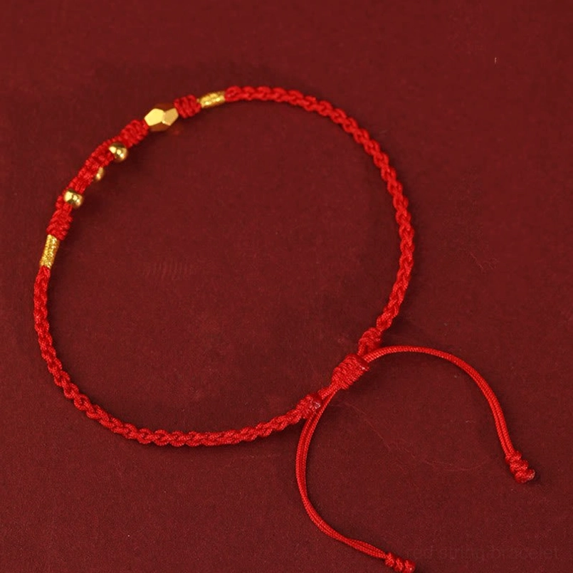 Full circular woven red string gold snake bracelet front view on solid red background