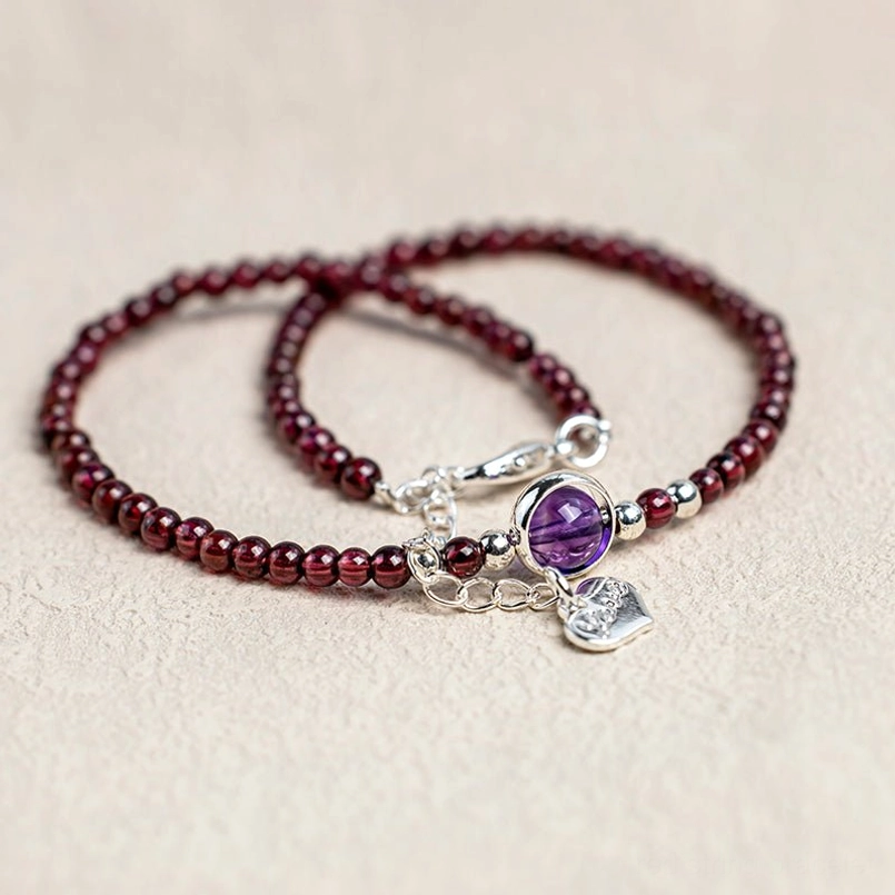 Two matching garnet amethyst anklets with purple gems and silver charms