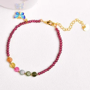 Garnet tourmaline butterfly bracelet and anklet with blue enamel charm on light background
