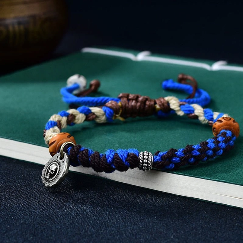 Tibetan Garuda red string bracelet with protective symbols and handcrafted details