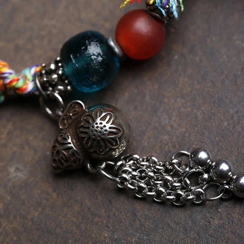 Blue glass bead, red agate, and carved silver flower charm with metal extender chain