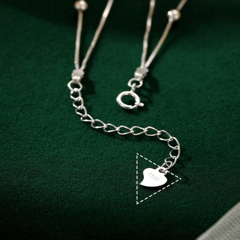 Silver anklet spring clasp and adjustable chain detail flat lay close-up