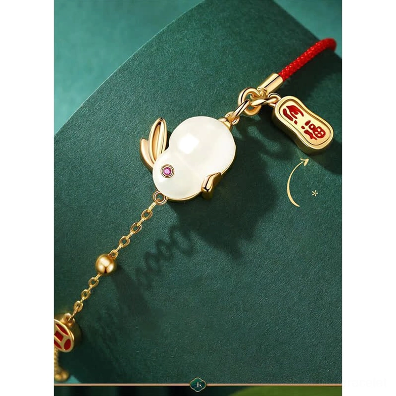 Glinting gold bead chain and enamel accent pendant close up of rabbit bracelet