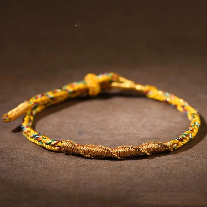 Gold Goat Monkey Tathagata red string bracelet close up