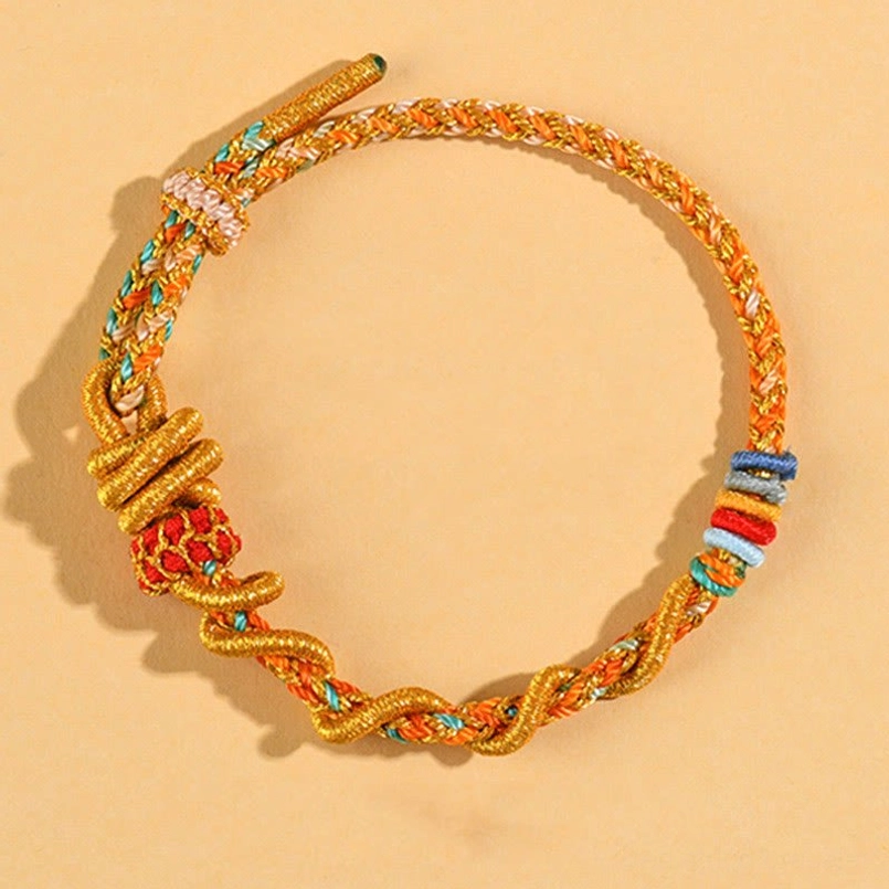 Gold-toned handmade luck bracelet with red knot and colorful beads – full product view