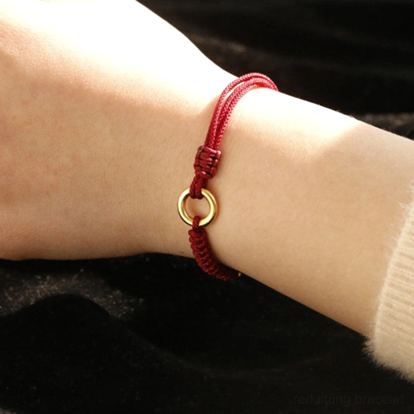 Red String Bracelet With Central Gold Peace Buckle Charm Overhead View