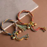 Pair of gold pixiu family blessing reincarnation knot bracelets with multicolor braided cord and enamel charms