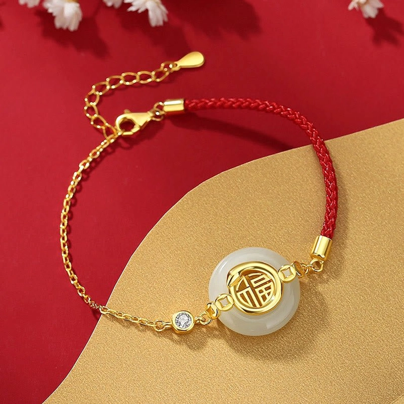 Adjustable gold Hetian jade peace buckle red string bracelet top flat lay
