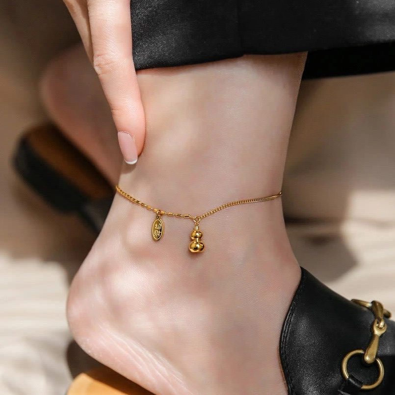 18k gold plated lucky gourd anklet worn on foot with dual prosperity charms
