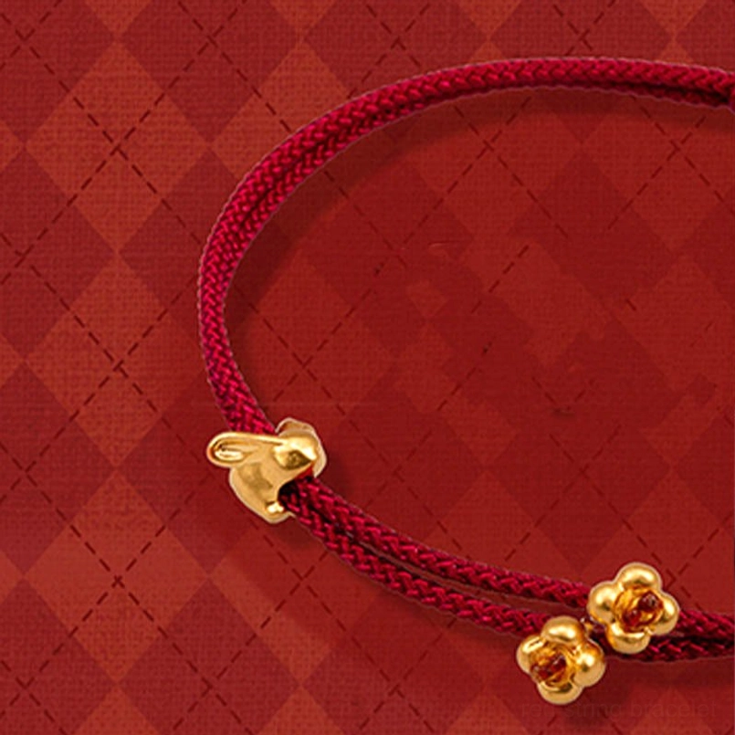 999 gold rabbit and osmanthus flower red string bracelet top down view