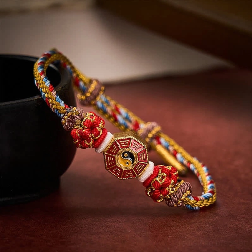 Gold tone red string Bagua protection bracelet side angle with charm accent