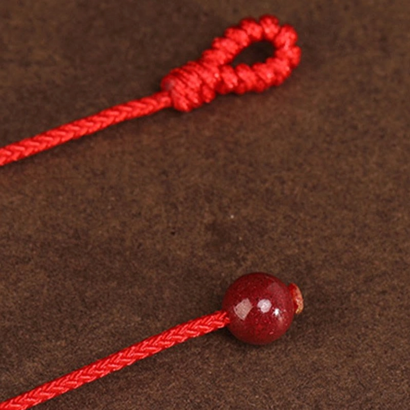 999 solid gold red string belly chain with cinnabar stone accent, close-up texture detail