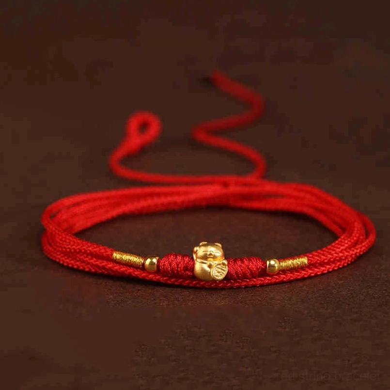 Hand modeling 999 gold red string belly chain showing comfort fit and weight on waist