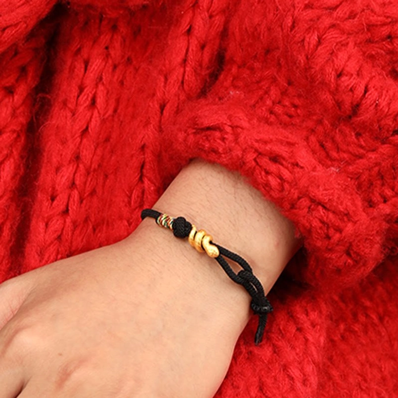 year of the snake red string bracelet close up with natural light shadow