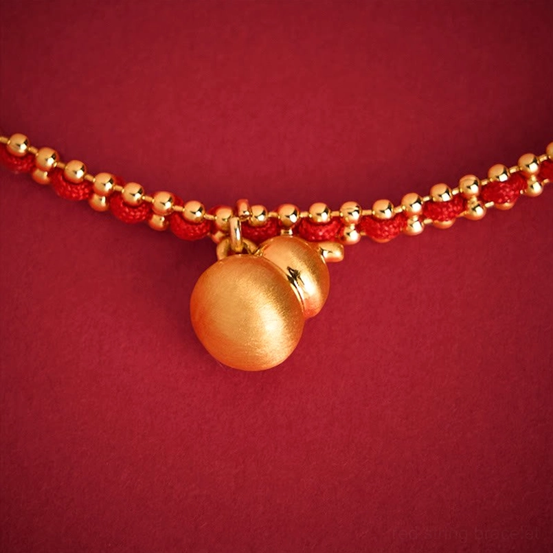 Close-up of double gourd brass pendant with delicate bead details
