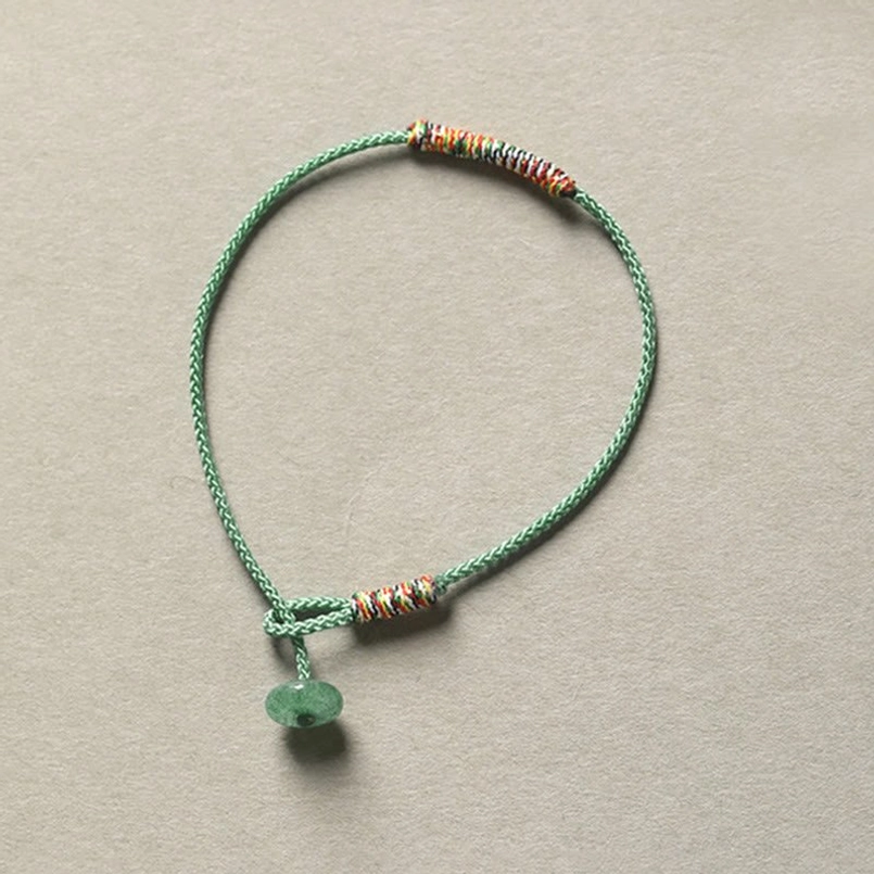 Green aventurine donut-shaped pendant Tibetan braided bracelet with beaded woven rope design