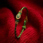 Green string bracelet with gold yuanbao charm close-up detail view