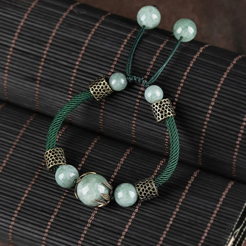 Adjustable pull-tie green jade luck bracelet with mixed-size jade beads - flat lay detail