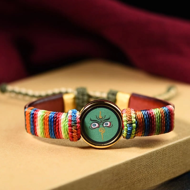 Green Jambhala eye blessing bracelet with multicolor rope and gold metal frame