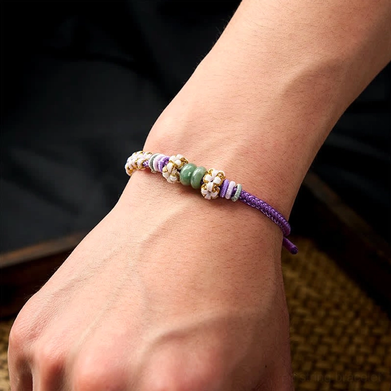 Green handmade bracelet showing weaving technique and jade stone positioning