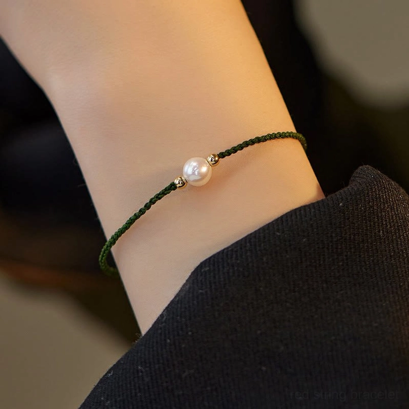 Green pearl string bracelet dark green woven cord white pearl gold beads worn on wrist