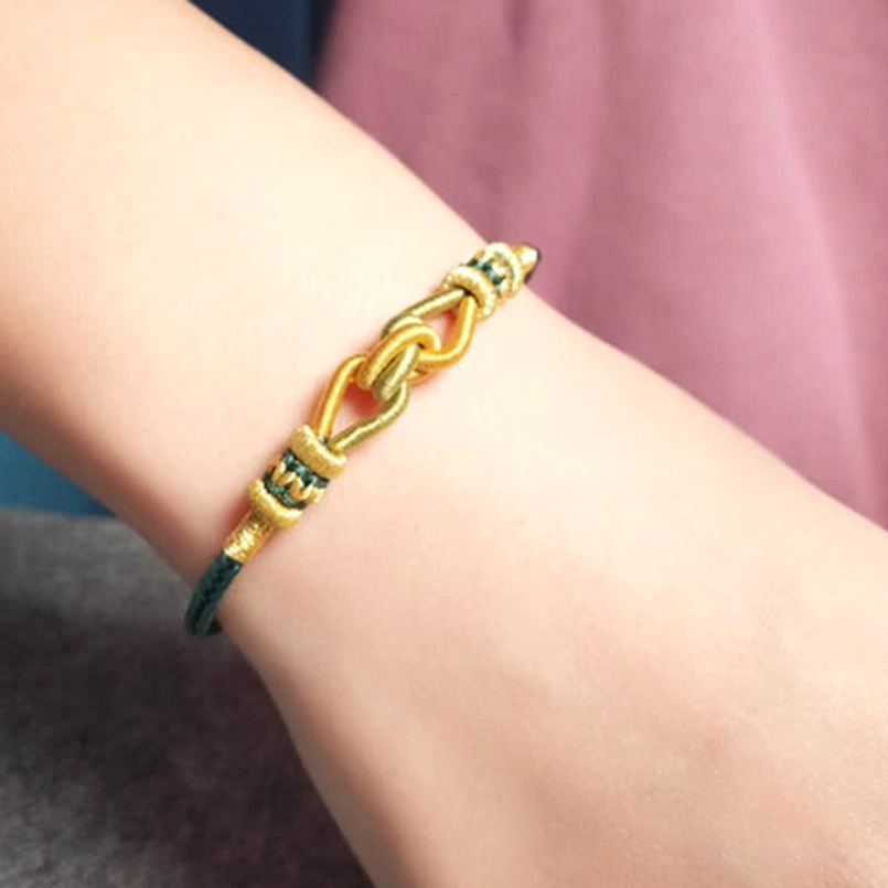 Handmade dark green braided string bracelet with gold woven details