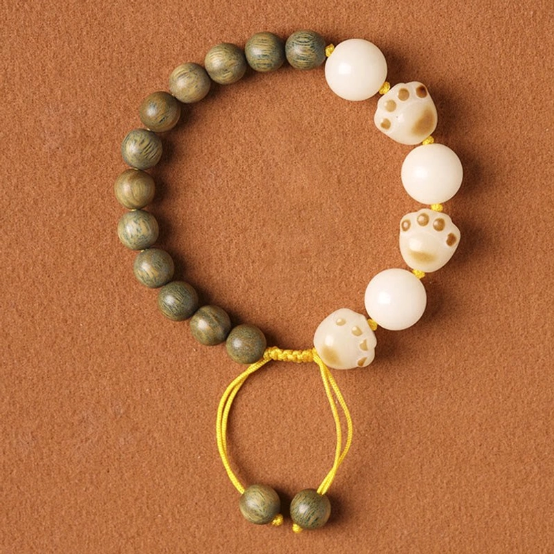 Natural Green Sandalwood Bodhi Seed Cat Paw Healing Bracelet Flat Lay Brown Background