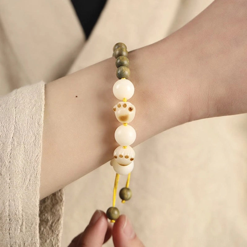 Green Sandalwood Bodhi Cat Paw Bracelet Wrist Wear View Beige Sleeve Background