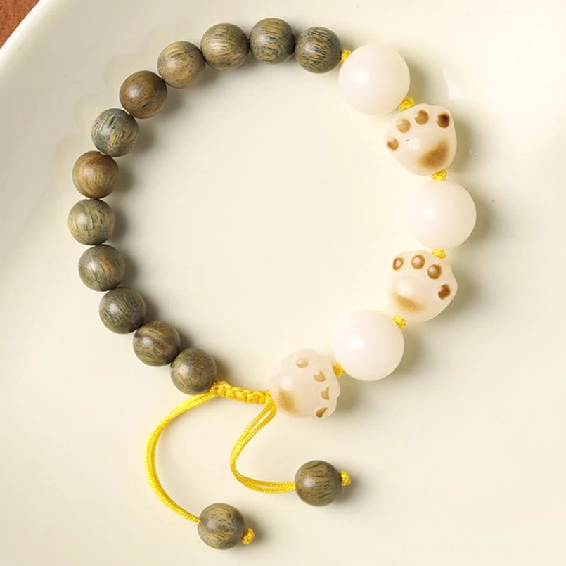Green Sandalwood Bodhi Cat Paw Bracelet Flat Lay White Background White Cat Paw Bead