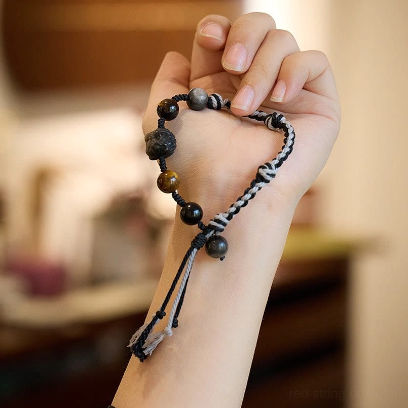 Dark cord obsidian tiger eye red string bracelet hand held display