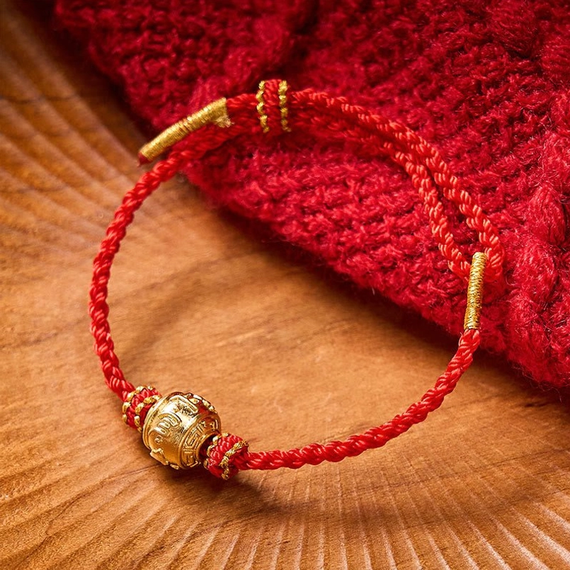 Hand-crafted red string protection bracelet showing artisanal braided cord craftsmanship